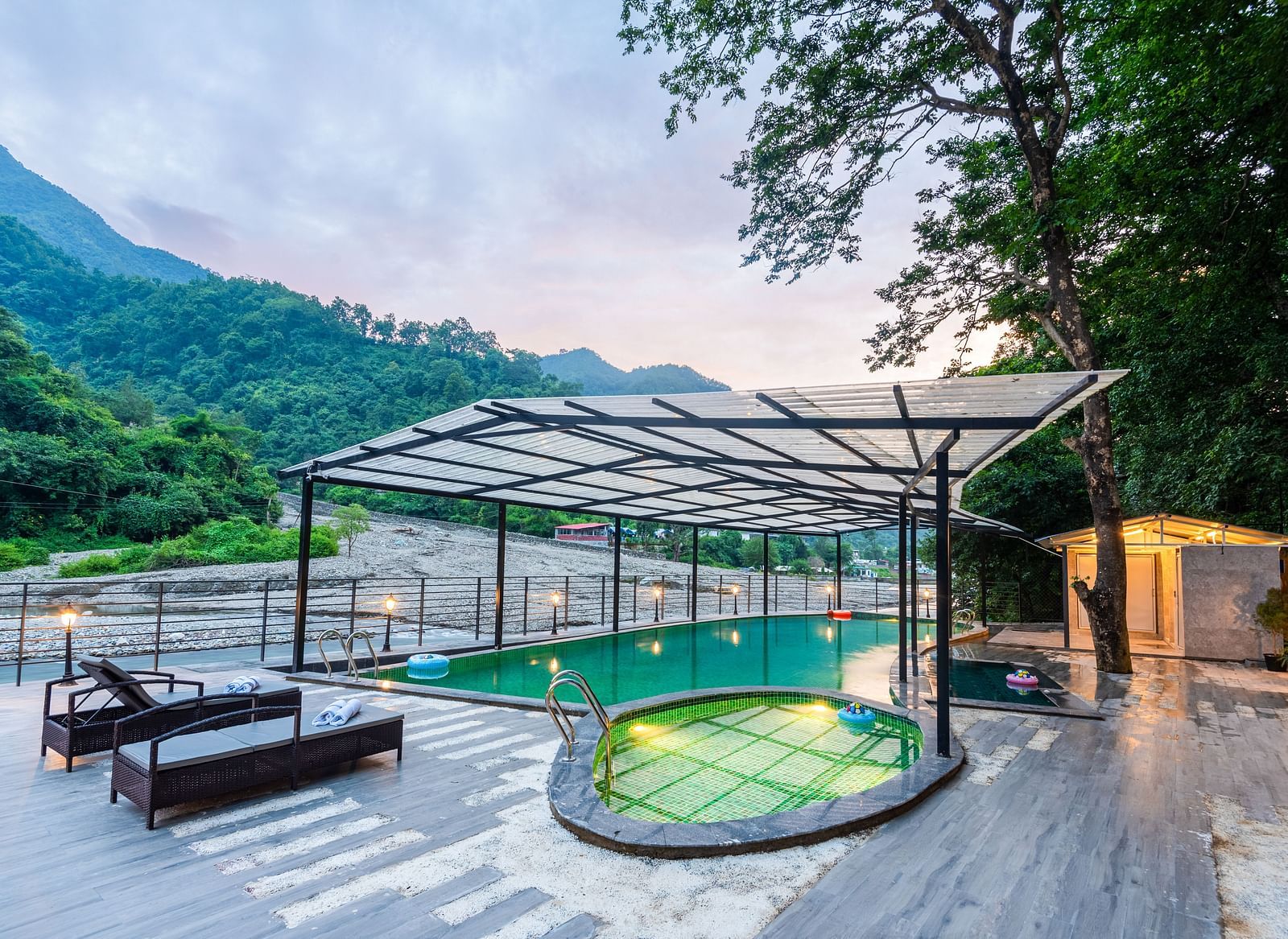 A swimming pool at DLS Divine River Resort and Spa with panoramic views and lounge chairs 